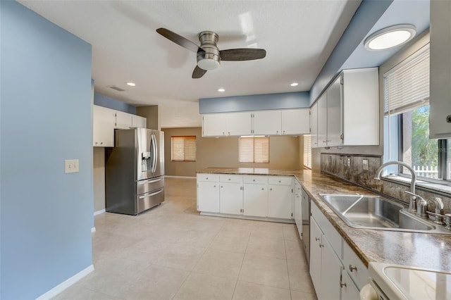 kitchen featuring ceiling fan, sink, backsplash, white cabinets, and appliances with stainless steel finishes