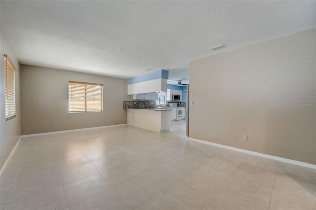 unfurnished living room featuring light tile patterned floors