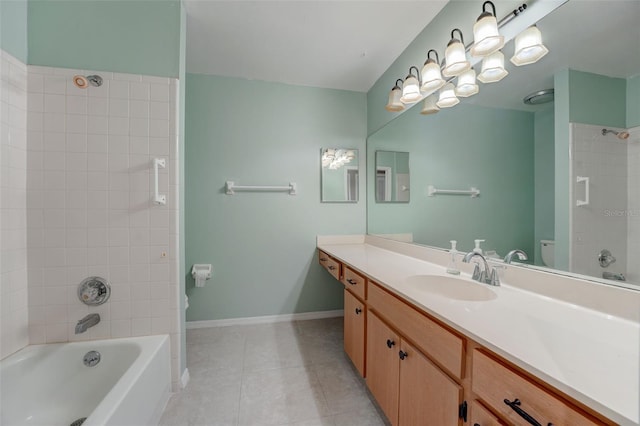 full bathroom featuring vanity, tiled shower / bath combo, and toilet