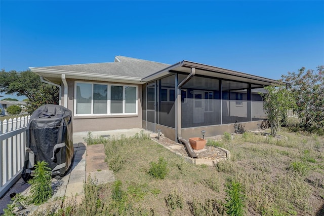 rear view of property with a sunroom