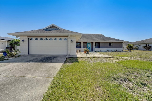 ranch-style house featuring central AC, a front yard, and a garage