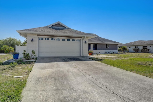 ranch-style house with a garage and a front lawn