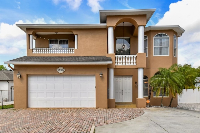 view of front facade featuring a garage and a balcony