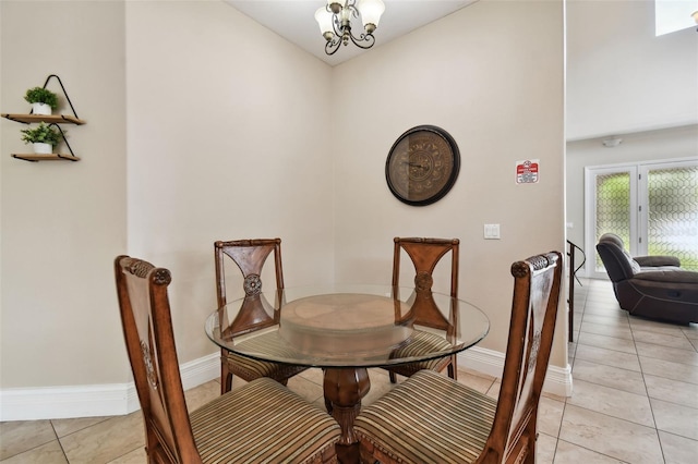 dining area with french doors, light tile flooring, and an inviting chandelier