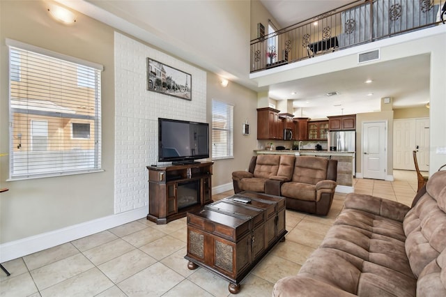 tiled living room with a towering ceiling