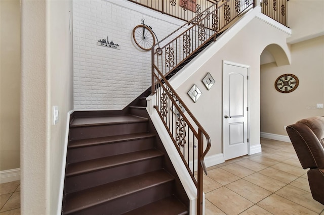 stairway featuring light tile flooring