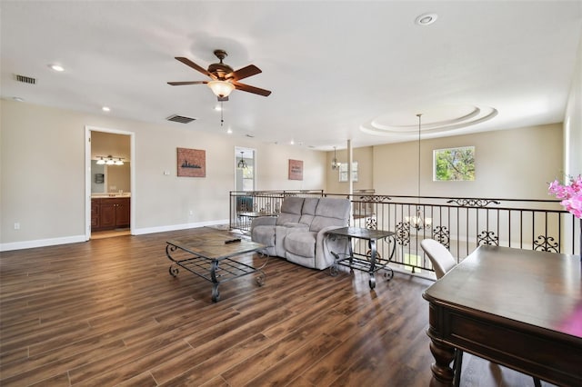 living room featuring dark hardwood / wood-style flooring and ceiling fan