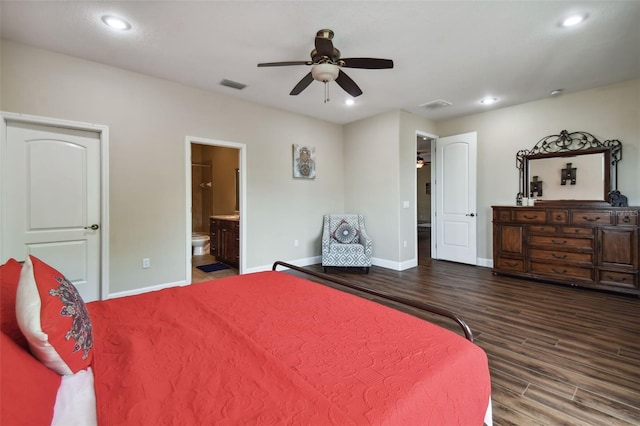 bedroom with ceiling fan, ensuite bath, and dark hardwood / wood-style floors