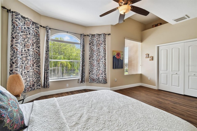 bedroom with a closet, dark hardwood / wood-style flooring, and ceiling fan