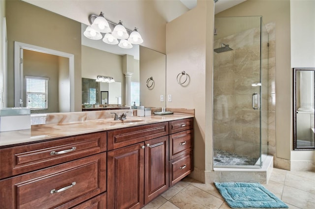 bathroom with vanity, tile floors, and a shower with shower door