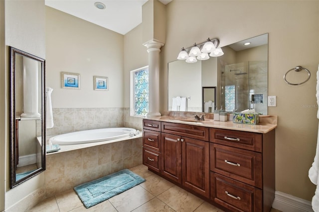 bathroom with vanity, tile floors, separate shower and tub, and decorative columns