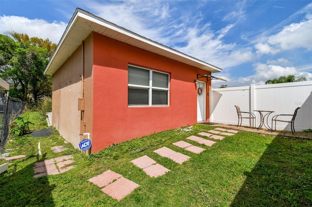 view of home's exterior with a lawn