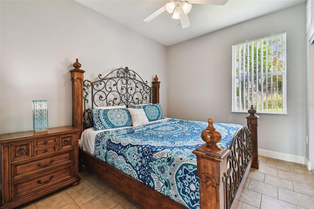 bedroom with ceiling fan and light tile flooring