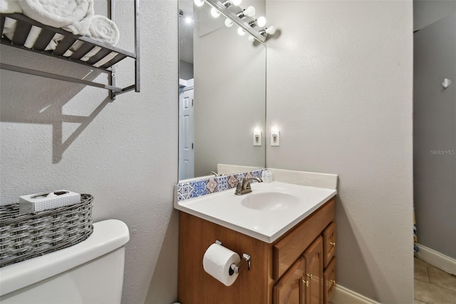 bathroom featuring vanity, toilet, and tile flooring