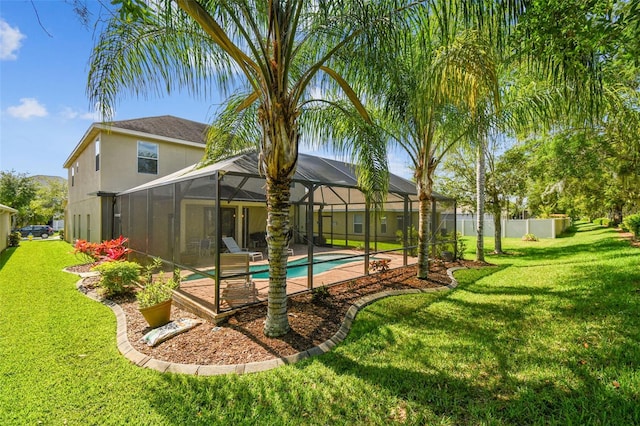 view of yard with a patio, glass enclosure, and a fenced in pool