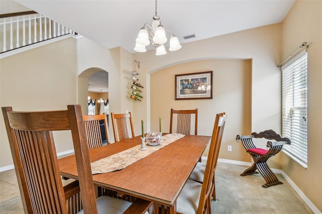 tiled dining room featuring a chandelier