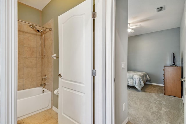 bathroom with ceiling fan, tile floors, and tiled shower / bath