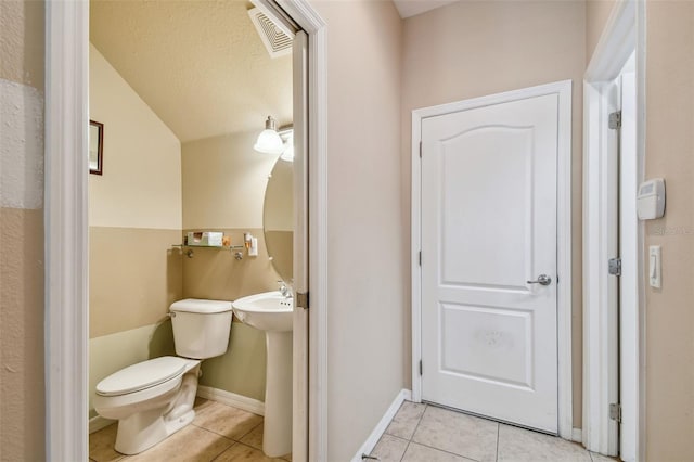 bathroom with toilet and tile floors