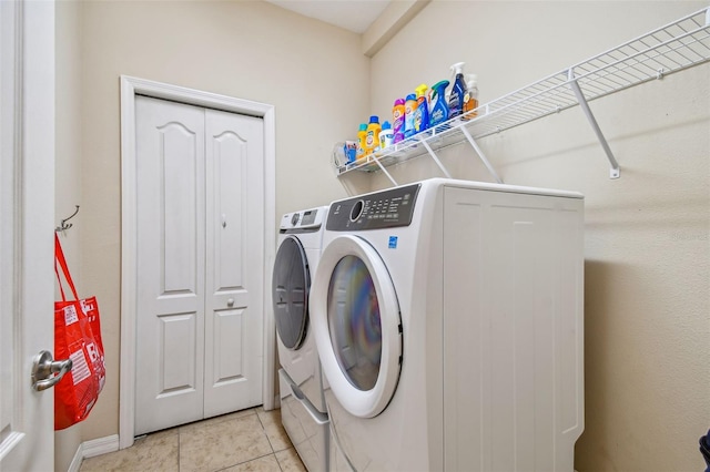 laundry room featuring light tile floors and independent washer and dryer