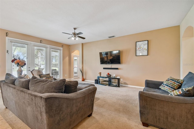 living room featuring ceiling fan and light colored carpet