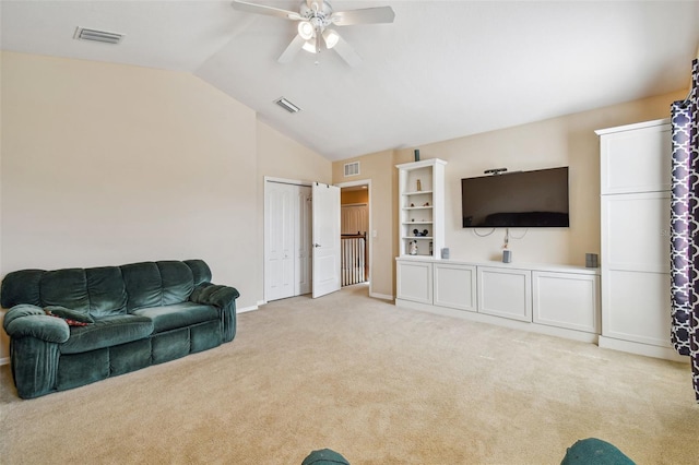 living room featuring ceiling fan, built in shelves, light colored carpet, and vaulted ceiling