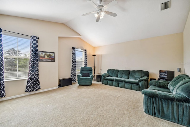 living room with lofted ceiling, ceiling fan, and light colored carpet