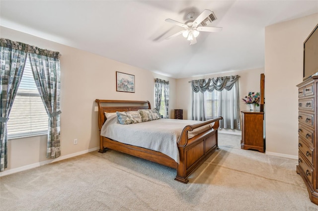 bedroom with ceiling fan and light colored carpet