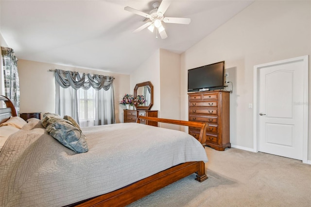 carpeted bedroom with ceiling fan and high vaulted ceiling