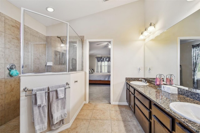 bathroom with ceiling fan, double sink vanity, tile floors, and a shower with door