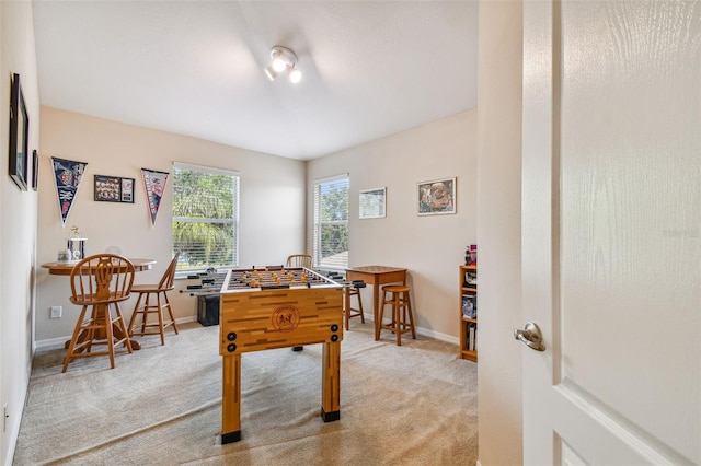 game room featuring light colored carpet