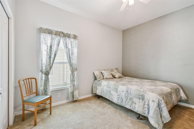 bedroom with ceiling fan, a closet, and light colored carpet