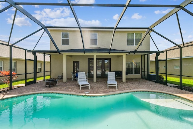 view of swimming pool with glass enclosure and a patio