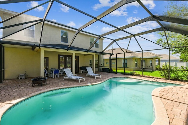 view of swimming pool with glass enclosure and a patio area