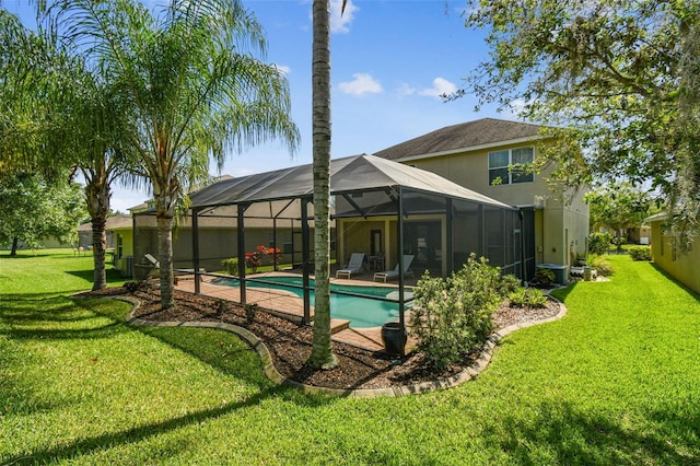 view of pool featuring glass enclosure and a yard