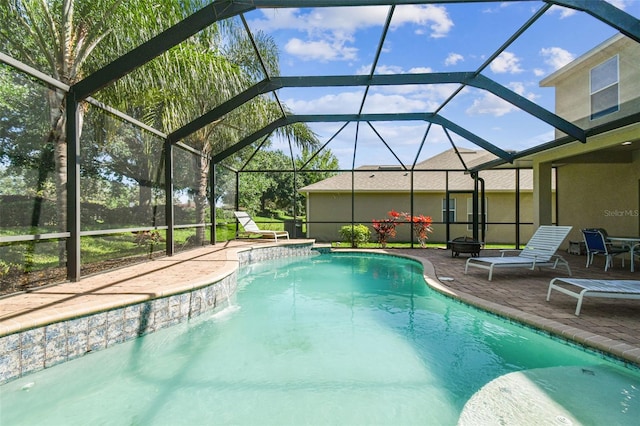 view of swimming pool with pool water feature, glass enclosure, and a patio area