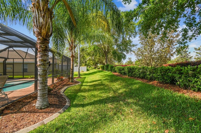 view of yard with glass enclosure and a fenced in pool