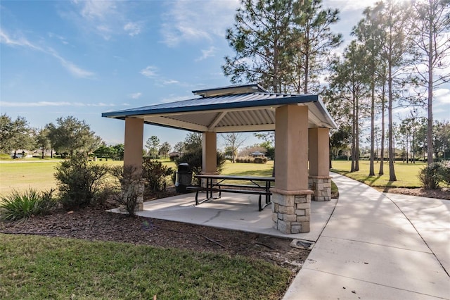 view of property's community with a lawn and a gazebo