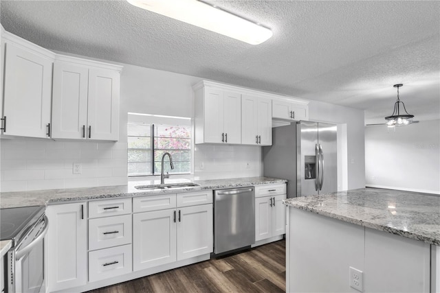 kitchen featuring appliances with stainless steel finishes, white cabinets, sink, and dark hardwood / wood-style floors