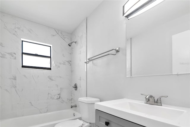 full bathroom featuring vanity, tiled shower / bath combo, and toilet