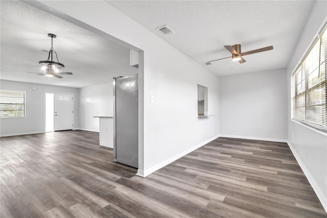 spare room featuring ceiling fan, a textured ceiling, and dark hardwood / wood-style floors