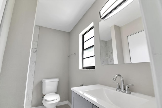 bathroom featuring toilet and vanity