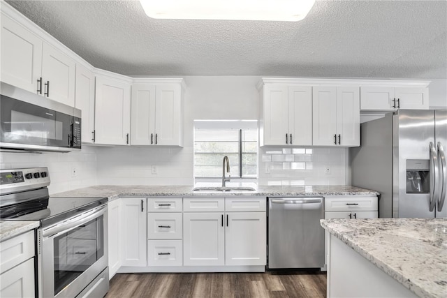 kitchen with sink, appliances with stainless steel finishes, and white cabinets