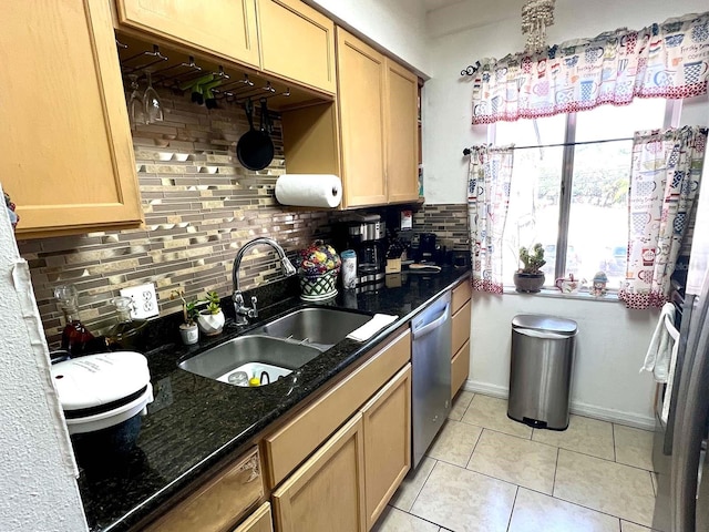 kitchen with backsplash, stainless steel dishwasher, light tile floors, and sink