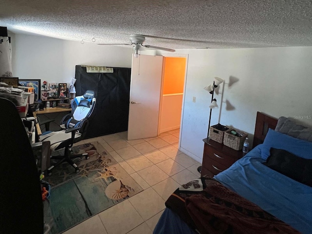 bedroom featuring tile floors, ceiling fan, and a textured ceiling