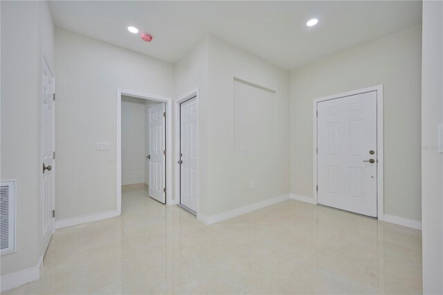 entrance foyer featuring light tile floors