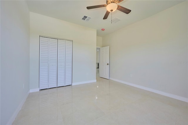 unfurnished bedroom with a closet, ceiling fan, and light tile floors