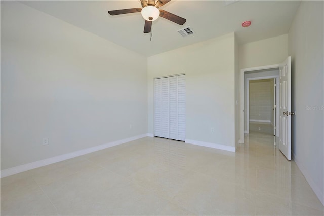 unfurnished bedroom featuring a closet, ceiling fan, and light tile flooring