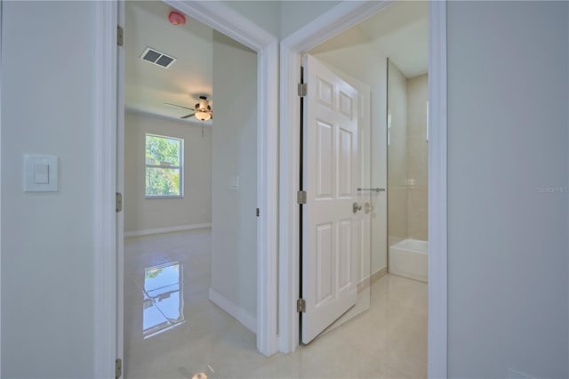 hallway featuring light tile floors