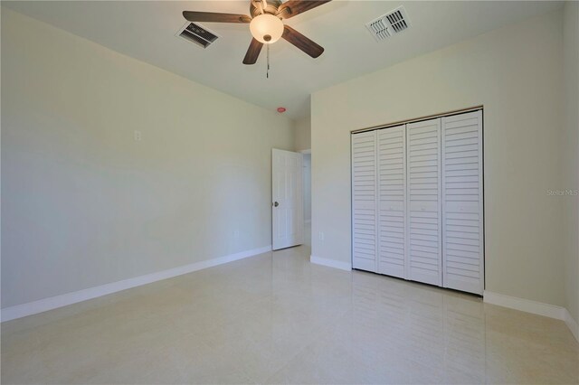 unfurnished bedroom featuring a closet, ceiling fan, and light tile floors