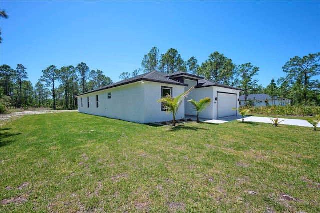 exterior space with a garage and a lawn